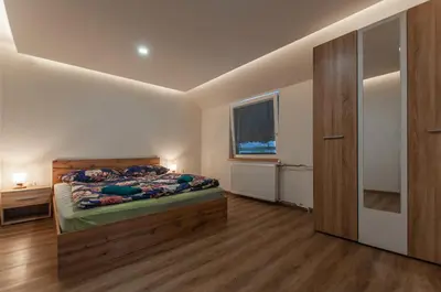 a bedroom with a bed and a window at Apartments Jože Pekovec in Bohinj