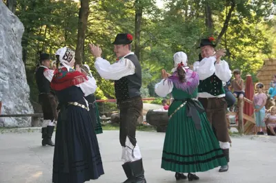 a group of people in folk costumes dancing at Accommodation Destina, LAKE BOHINJ in Bohinj