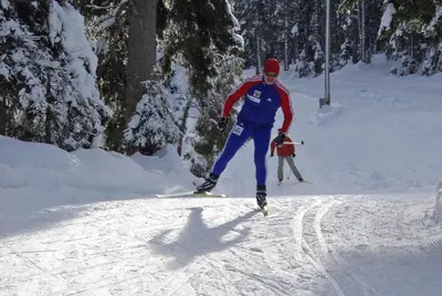 a man is skiing down a snow covered slope at Accommodation Destina, LAKE BOHINJ in Bohinj