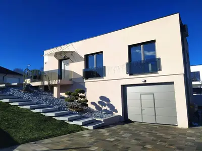 a white house with a garage at Place near Casino Mond - Apartma Urška in Šentilj