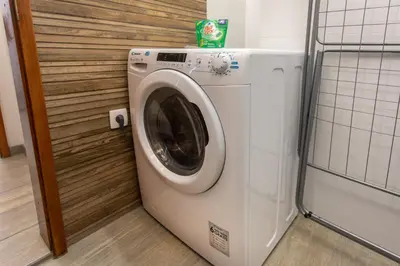 a washer and dryer in a small room at Stay in pub KAMERA KLUB apatment-city center in Ljubljana