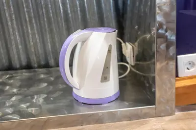 a white and purple appliance sitting on a counter at Stay in pub KAMERA KLUB apatment-city center in Ljubljana