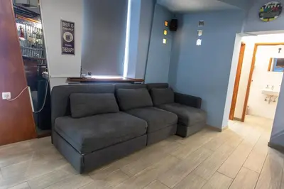 a living room with a couch in a store at Stay in pub KAMERA KLUB apatment-city center in Ljubljana