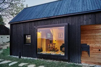 a black building with a large window on it at Tri Vile Estate, a piece of paradise in Kozjansko in Podčetrtek