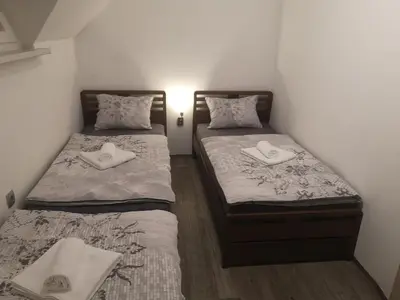 two beds in a small room with towels on them at APP Vanja 6170 in Čatež ob Savi