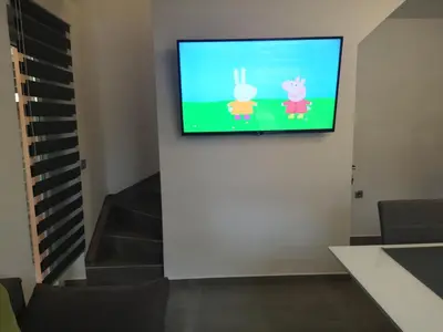 a flat screen tv on a wall in a living room at APP Vanja 6170 in Čatež ob Savi