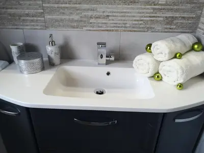 a bathroom sink with towels on top of it at APP Vanja 6170 in Čatež ob Savi