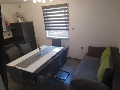 a living room with a table and a couch at APP Vanja 6170 in Čatež ob Savi