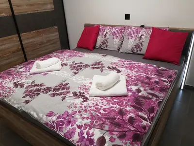 a bed with two white towels on top of it at APP Aleksa 6168 in Čatež ob Savi