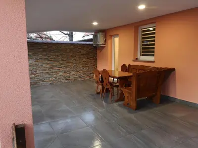 a dining room with a wooden table and chairs at APP Aleksa 6168 in Čatež ob Savi