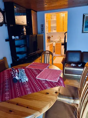 a dining room table with a red table cloth on it at Apartma Snežinka in Kranjska Gora