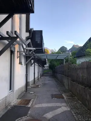 an alley with a building with awning on the side at Apartma Snežinka in Kranjska Gora