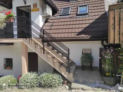 a stairway to a house with a bench and flowers at ODAI in Bovec