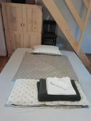 a bed with two white towels on top of it at ODAI in Bovec