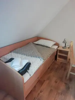a bed with a wooden frame in a room at ODAI in Bovec