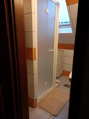 a bathroom with a toilet and a glass door at ODAI in Bovec