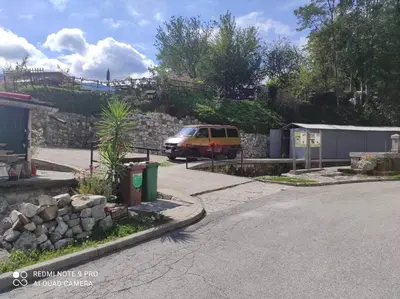 a van parked on the side of a street at ODAI in Bovec