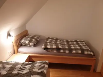 a bedroom with a bed with two pillows on it at Apartma DA-LI SPORTS -ROGLA in Zreče