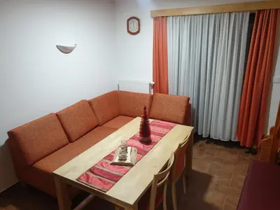 a living room with a couch and a table at Apartma DA-LI SPORTS -ROGLA in Zreče