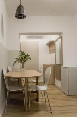 a dining room table and chairs in a room at Jantar Apartmaji in Novo Mesto