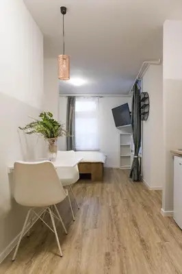 a room with a table and a bed in it at Jantar Apartmaji in Novo Mesto