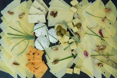 a plate of cheese and nuts on a table at Guesthouse Lajnar in Zgornja Sorica