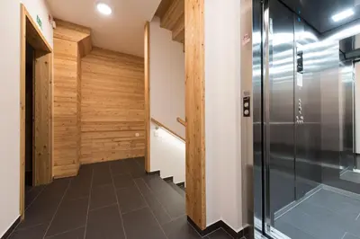 a hallway with wood paneling and a refrigerator at Guesthouse Lajnar in Zgornja Sorica