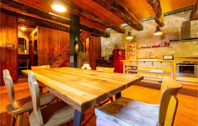 a kitchen with a wooden table and chairs at Amazing Home In Tolmin With Sauna in Tolmin