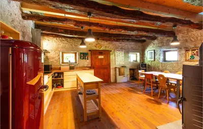 a kitchen with a table and chairs in a room at Amazing Home In Tolmin With Sauna in Tolmin