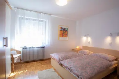 a bedroom with a large bed and a window at Apartment Melody Bled in Bled