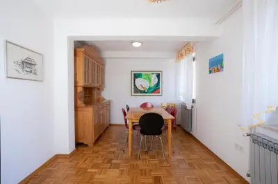 a kitchen with a table and chairs in a room at Apartment Melody Bled in Bled