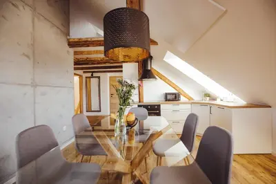 a dining room with a table and chairs at Drive Caffe Apartments in Trzin