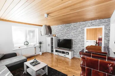 a living room with a couch and a tv at Drive Caffe Apartments in Trzin
