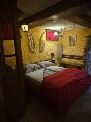 a bedroom with a bed in a room with yellow walls at Apartma Miša, Tomo Ketiš sp in Prevalje