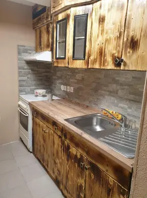 a kitchen with a sink and a stove at Apartma Miša, Tomo Ketiš sp in Prevalje