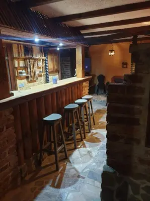a row of stools at a bar in a restaurant at Apartma Miša, Tomo Ketiš sp in Prevalje