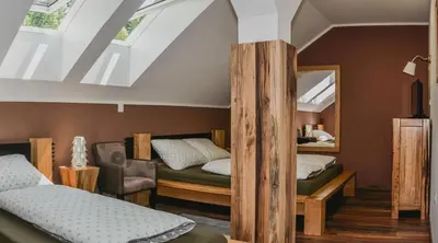 a bedroom with two beds and a mirror at Ta Fabrika Restavracija,pizzerija in prenočišča in Dravograd