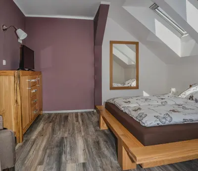 a bedroom with a bed and a mirror at Ta Fabrika Restavracija,pizzerija in prenočišča in Dravograd