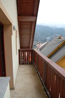 a balcony with a view of a roof at Apartmaji Kramar Rateče in Kranjska Gora