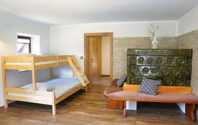 a room with two bunk beds and a couch at Apartmaji Katja in Bohinj