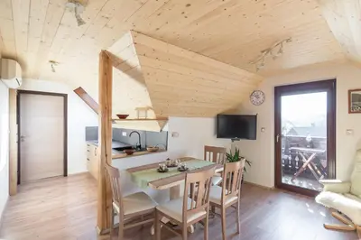 a kitchen and dining room with a table and chairs at Apartmaji Katja in Bohinj
