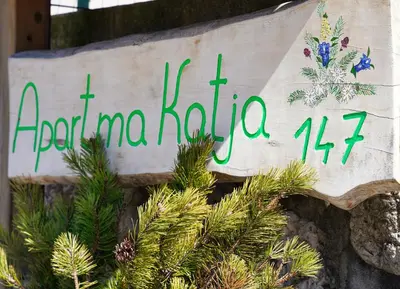 a sign on a wall with christmas trees at Apartmaji Katja in Bohinj