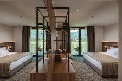 a hotel room with two beds and a balcony at Hotel Grof in Vransko