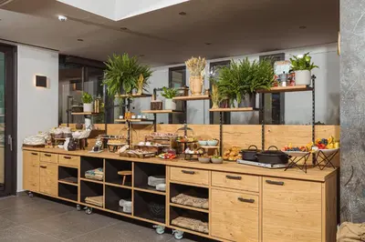 a large wooden counter with plants on it at Hotel Grof in Vransko