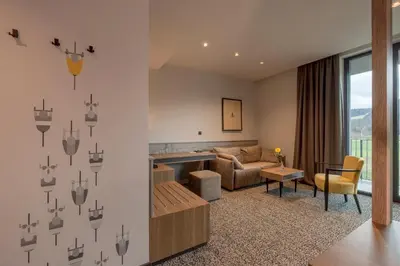 a living room with a couch and a table at Hotel Grof in Vransko