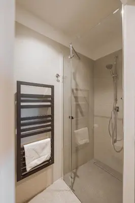 a bathroom with a shower and a glass shower stall at Hotel Grof in Vransko