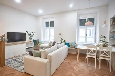 a living room with a couch and a table at FERN apartments in Maribor