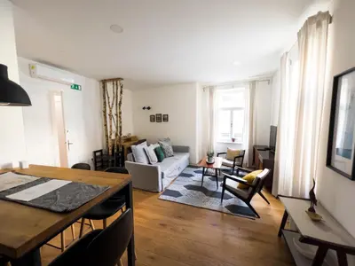 a living room with a table and a couch at FERN apartments in Maribor