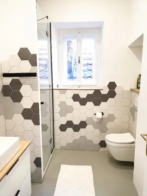 a bathroom with a toilet and a shower at FERN apartments in Maribor
