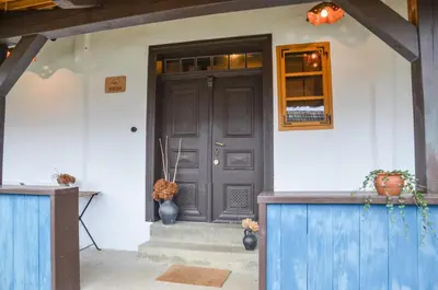 a front door of a house with a vase on the doorstep at GORIČKE IŽE in Križevci